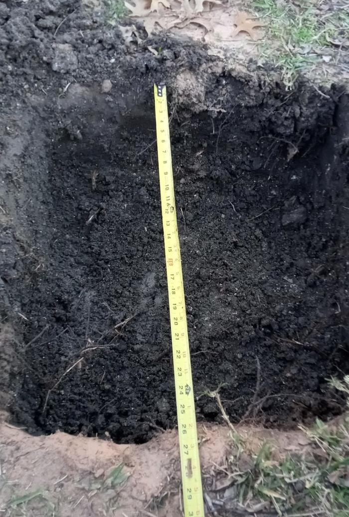 hole with wet dirt in it 2 feet wide