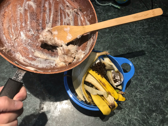 Scraping the fat into the compost.