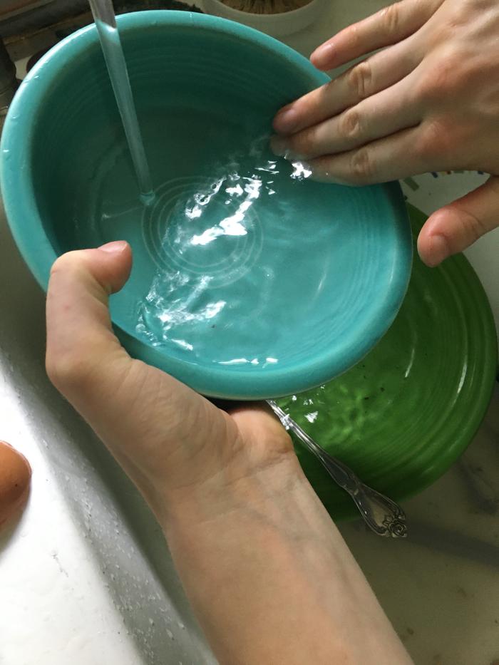 Washing the bowl with hot water 