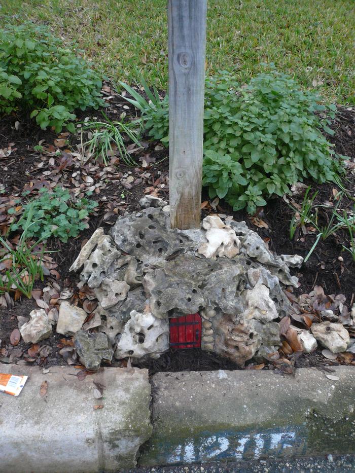 tiny mystery door in urban shade garden