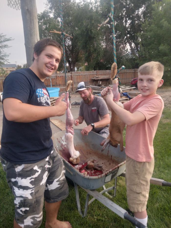 My son teaches his friend and uncle to clean and process 2 rabbits at a time