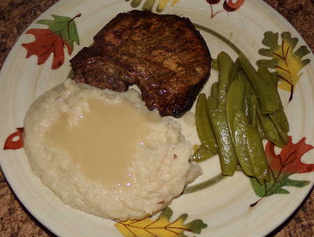 Mashed groundnuts with homegrown frozen snow peas, but I bought the pork chops.