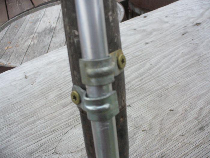 Lower part of tube attached with 2 conduit clamps