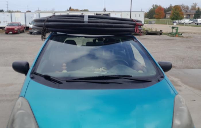 geothermal heat pump pipe tied to a roof rack on a car