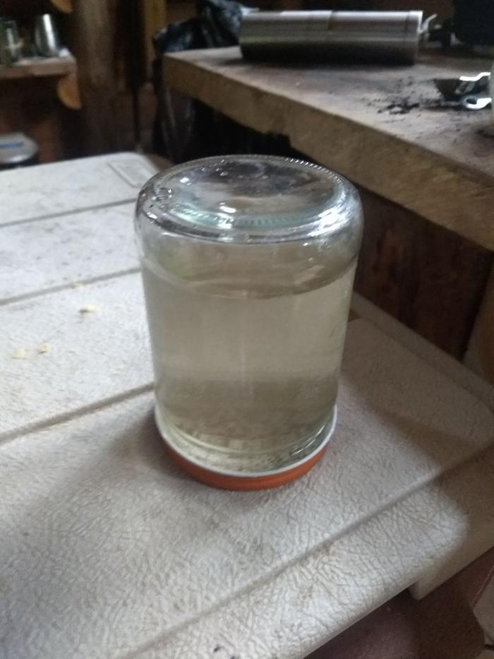 A small jar with water and a bit of coffee... and a lid that seals