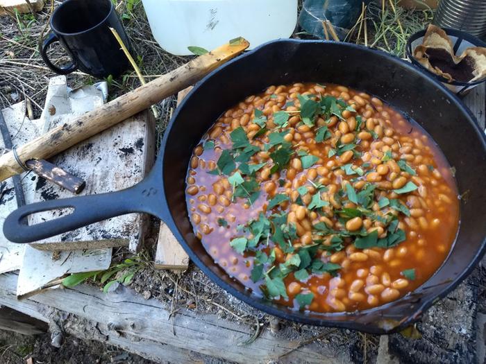 Chopped serviceberry and wild rose leaves added to baked beans