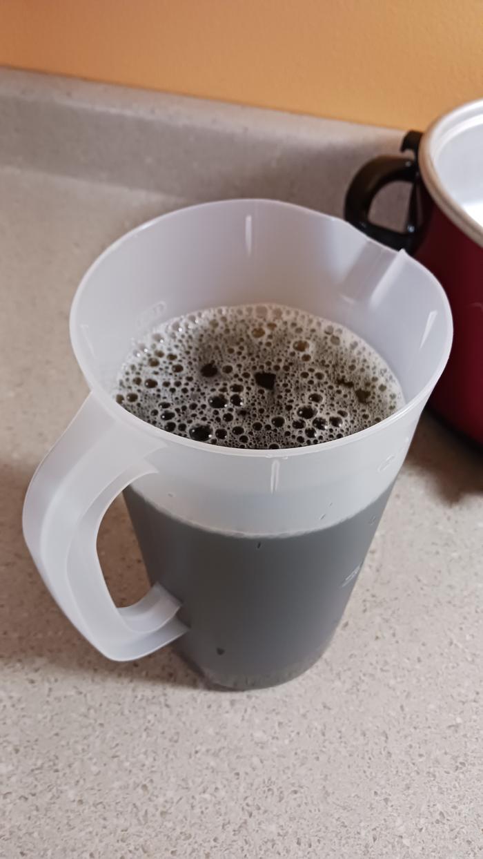 On my wife's suggestion I used one of those wide pasta strainers to remove the leaves. Then I poured it into a pitcher. Dark and a little bit soapy