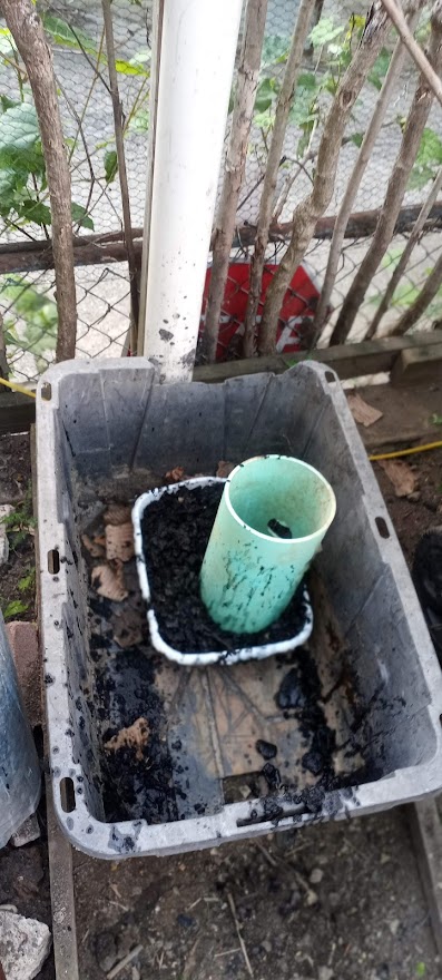 Dish pan filled with charcoal, pipe filled with carbonous material.