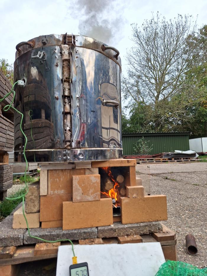 the pottery kiln running with smoke coming out of the kiln