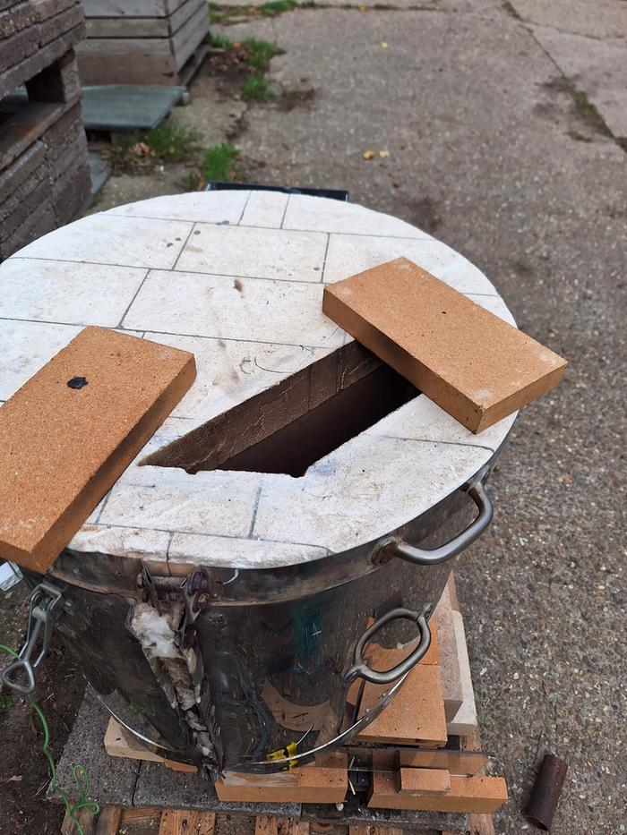 bricks to throttle the exhaust of a rocket fired pottery kiln