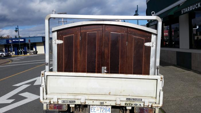 The camper occupies the whole deck, leaving just enough room for him to access the big tool box.