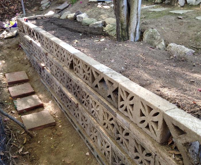 Basically three cinder blocks tall (around 3 feet), with the big rotting logs placed on the bottom, then various layers on top.