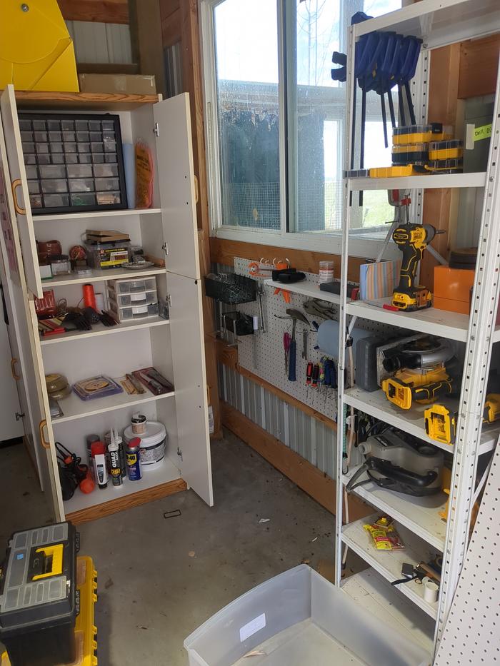 I hung up this pegboard and hung a bunch of tools and put supplies in the cupboard. We can actually find things now!