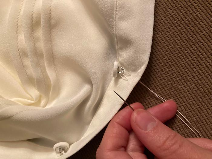 handsewing on a button