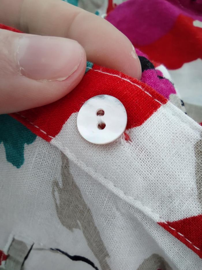 Button in the hand sewed buttonhole