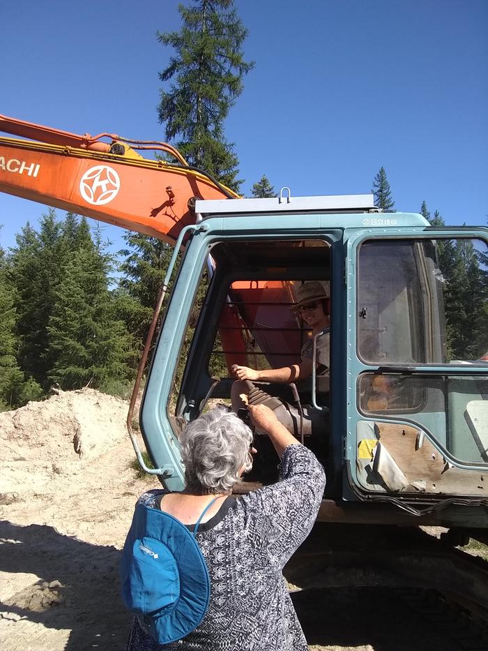 Mary gives some pointers on driving the excavator