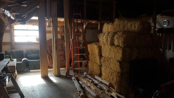 Straw bales stored temporarily in the Auditorium, to be used for insulation and cob projects