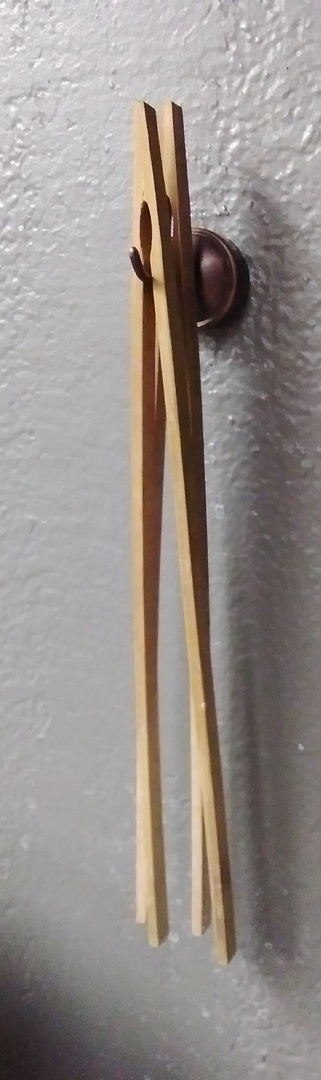 Here is the hook in use with a couple bamboo tongs on it.