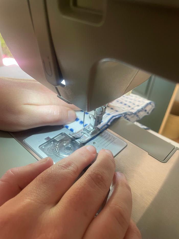 machine sewing a small pillow