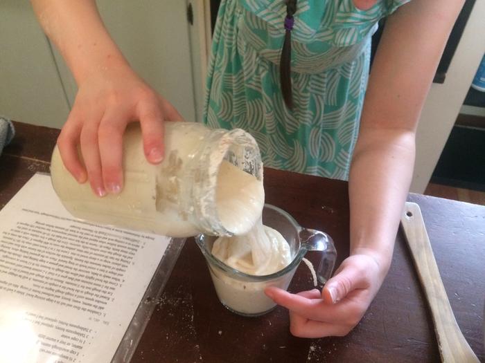 pouring sourdough starter 