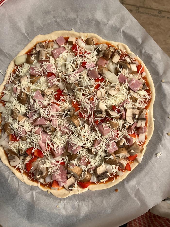 pizza with toppings before baking