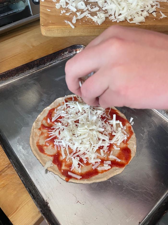 Toppings: tomato sauce, cheese, savory. Put the pizza in the oven at 450F for about 8 minutes 