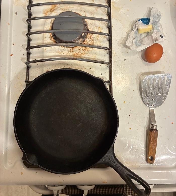 Prepped and ready: cast iron pan, egg, salted butter, Gramma's steel spatula.