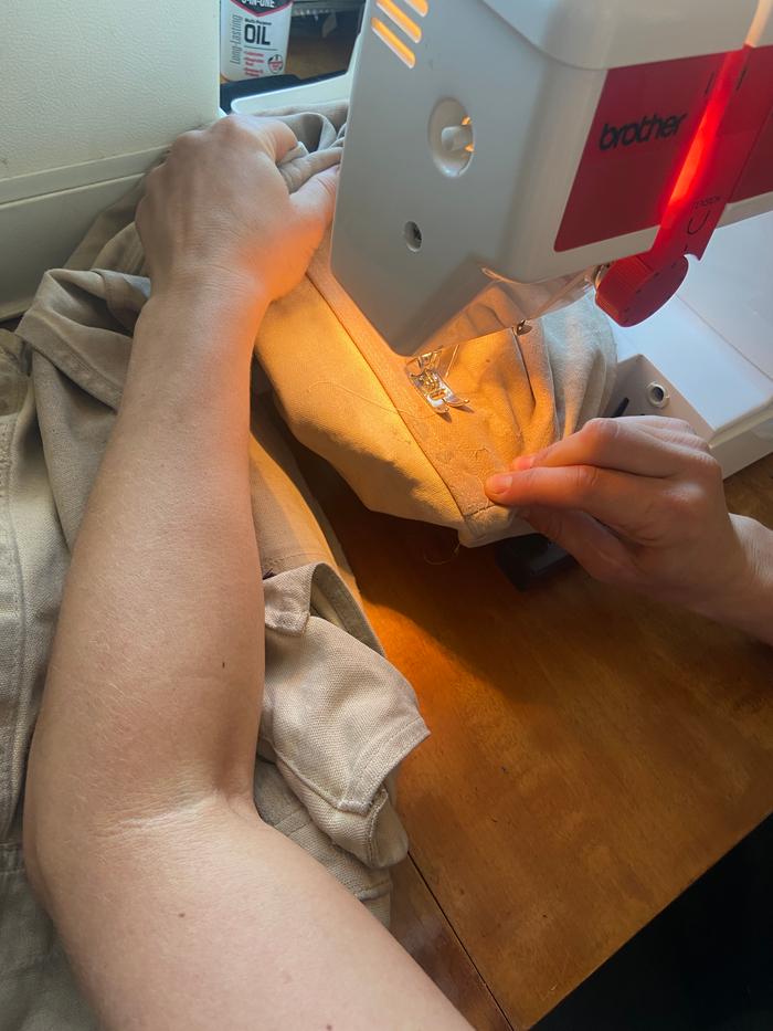 machine mending a hole in overalls