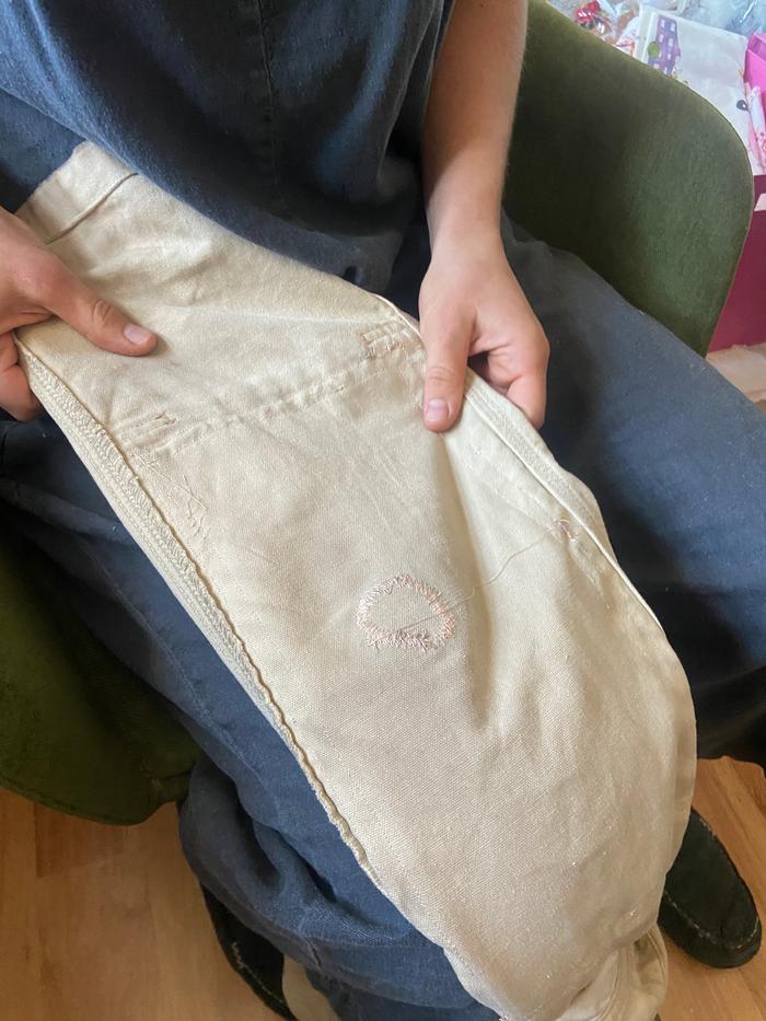 machine mending a hole in overalls