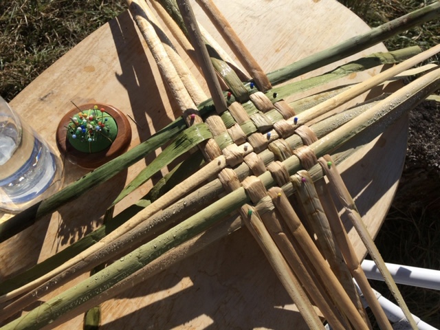 Soaked cattails are pinned to the form. Spritzed with a spray bottle to keep the reeds pliable.