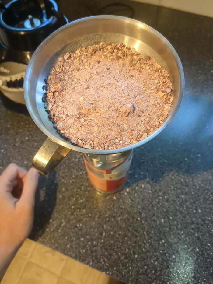 Putting the grounds in a bottle.