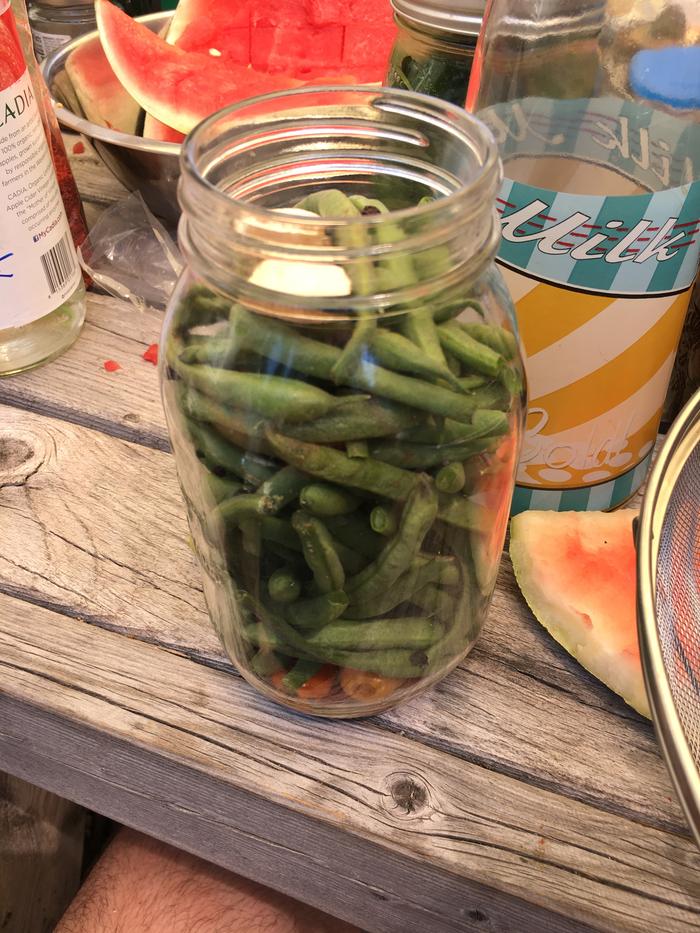 placing beans in a jar