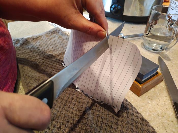 Sharpened knife cut paper cleanly.
