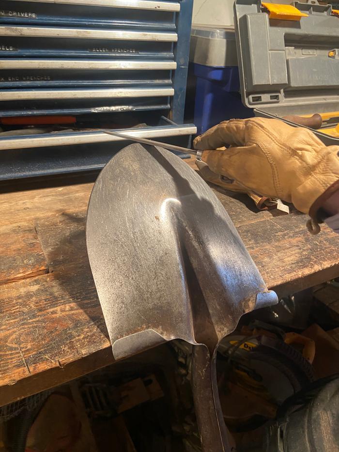 sharpening a shovel with a file in the shop at wheaton labs. You could live there for no moneys and learn all about permaculture