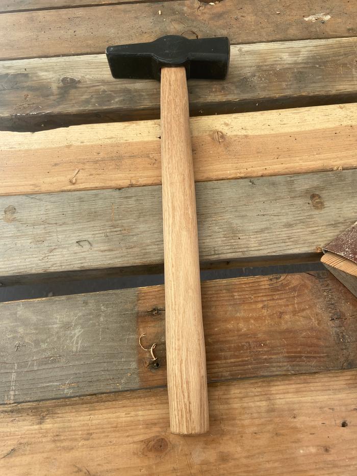 homemade handle in a hammer on a lumber table