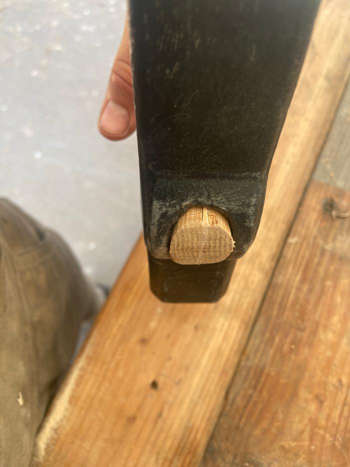 A wooden wedge installed in a hammer handle