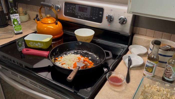 Onions, carrots, garlic, ginger in the pan