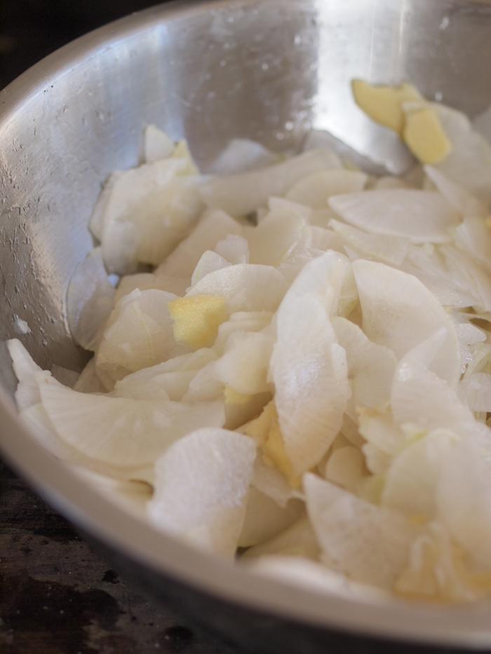 Daikon, salt, and ginger in a bowl.