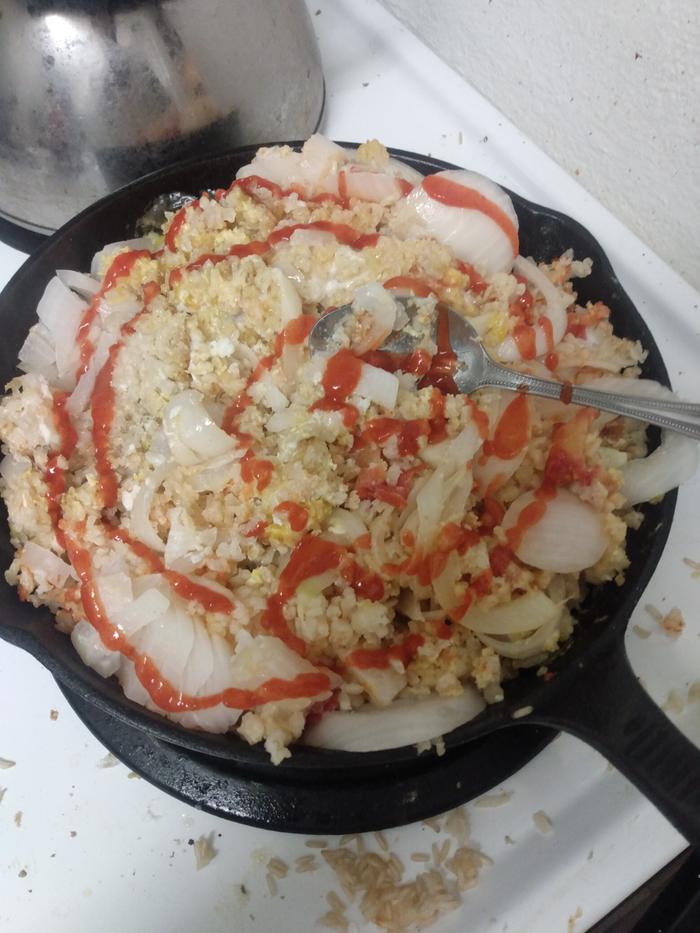 Several eggs, plenty of salt, oil, a diced tomato, Sriracha, and onion. Ate some, fridged the rest. There's actually still some rice in the original pot too.