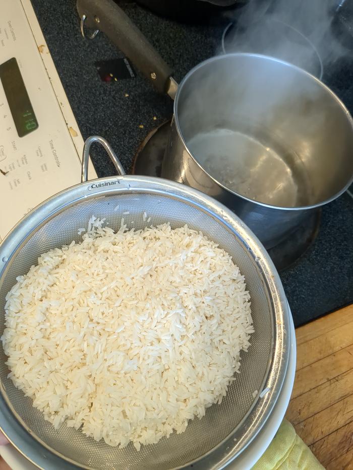 Rinsed and put in boiling water. It was about 3.75 cups of water (less than 4 cups because the rice has already absorbed some moisture).