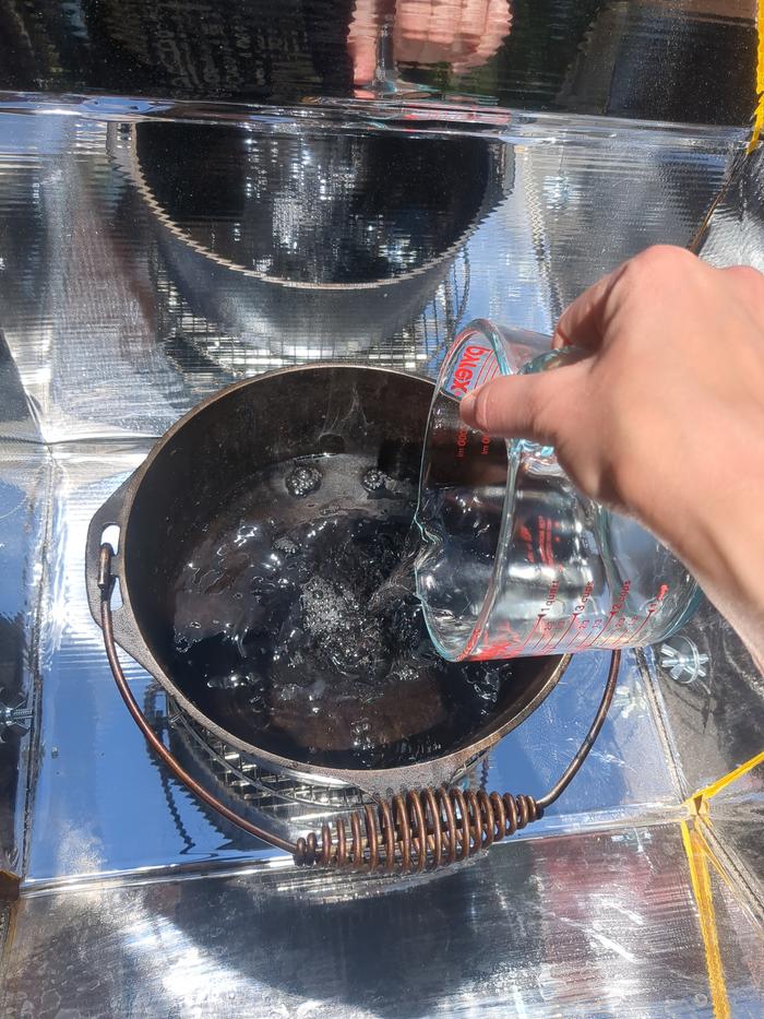 Putting the water in.