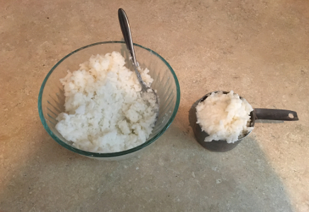 Rice in bowl and 1 cup measure cup to show volume