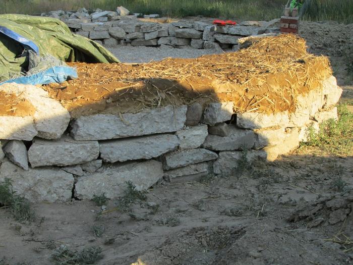 urbanite on rubble trench foundation leveled with cob