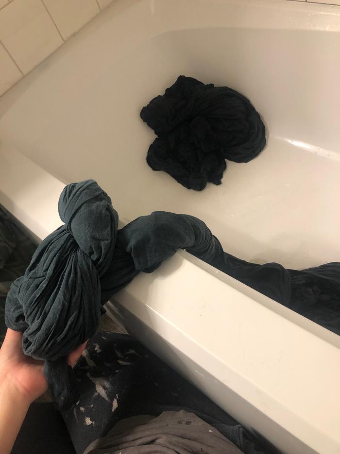 Wringing by hand. Painstakingly. 