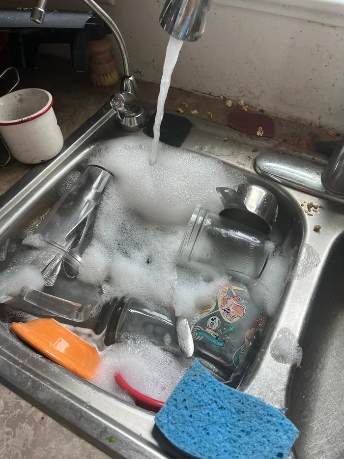 I add hot water and soap to the sink