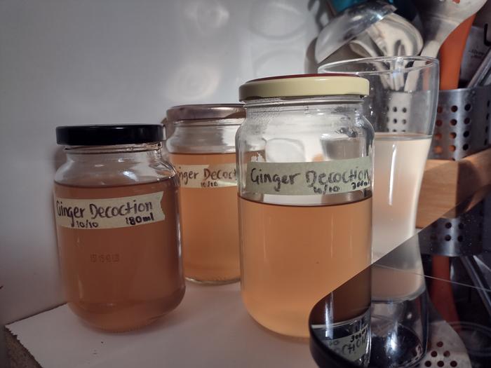 Finished Ginger Decoction, labelled with date and quantity. Ready made ginger drink in background.