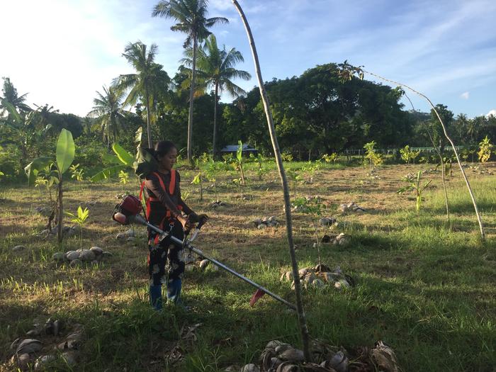 my sister is helping me cutting the weeds