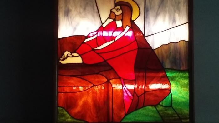 Jesus Christ kneeling while praying on Rock