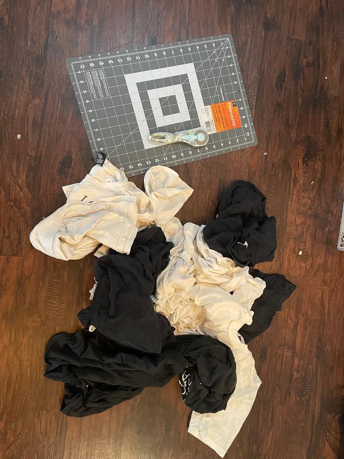 Pile of old shirts and my rotary cutter and mat. 
