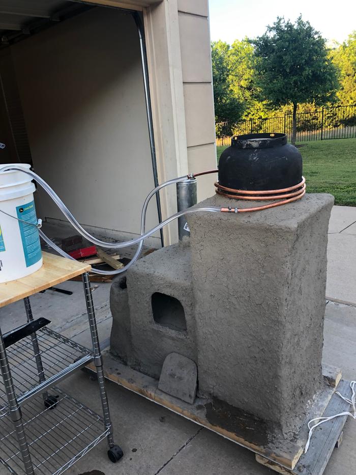 coils around the riser of a rocket stove for water heating